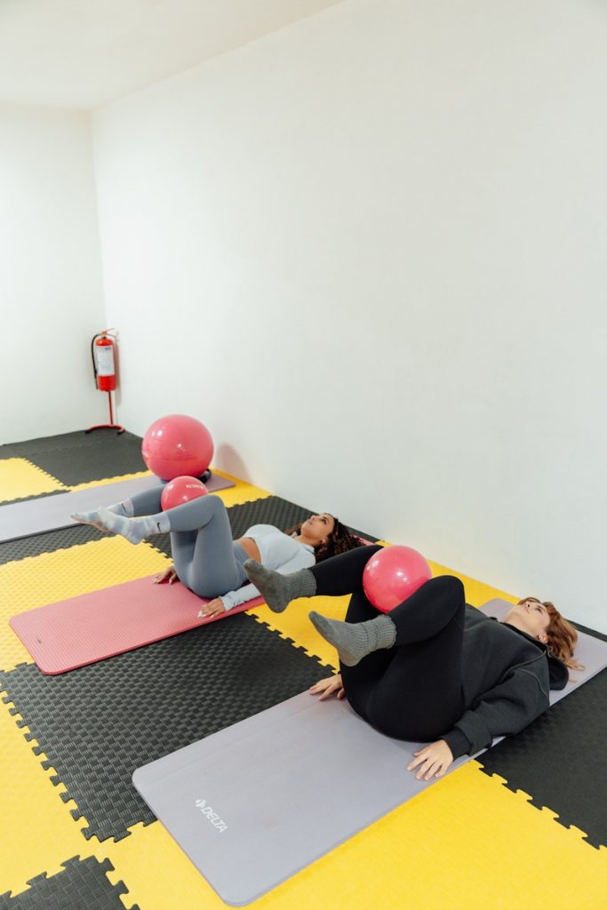 a group of people doing yoga in a room